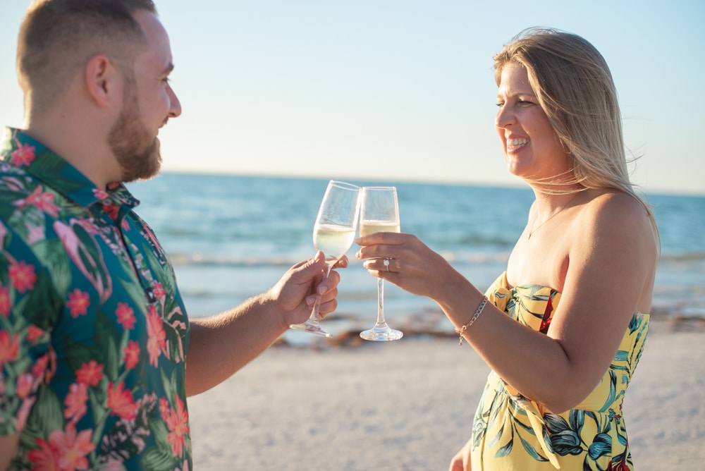 Couple drinking champagne on beach